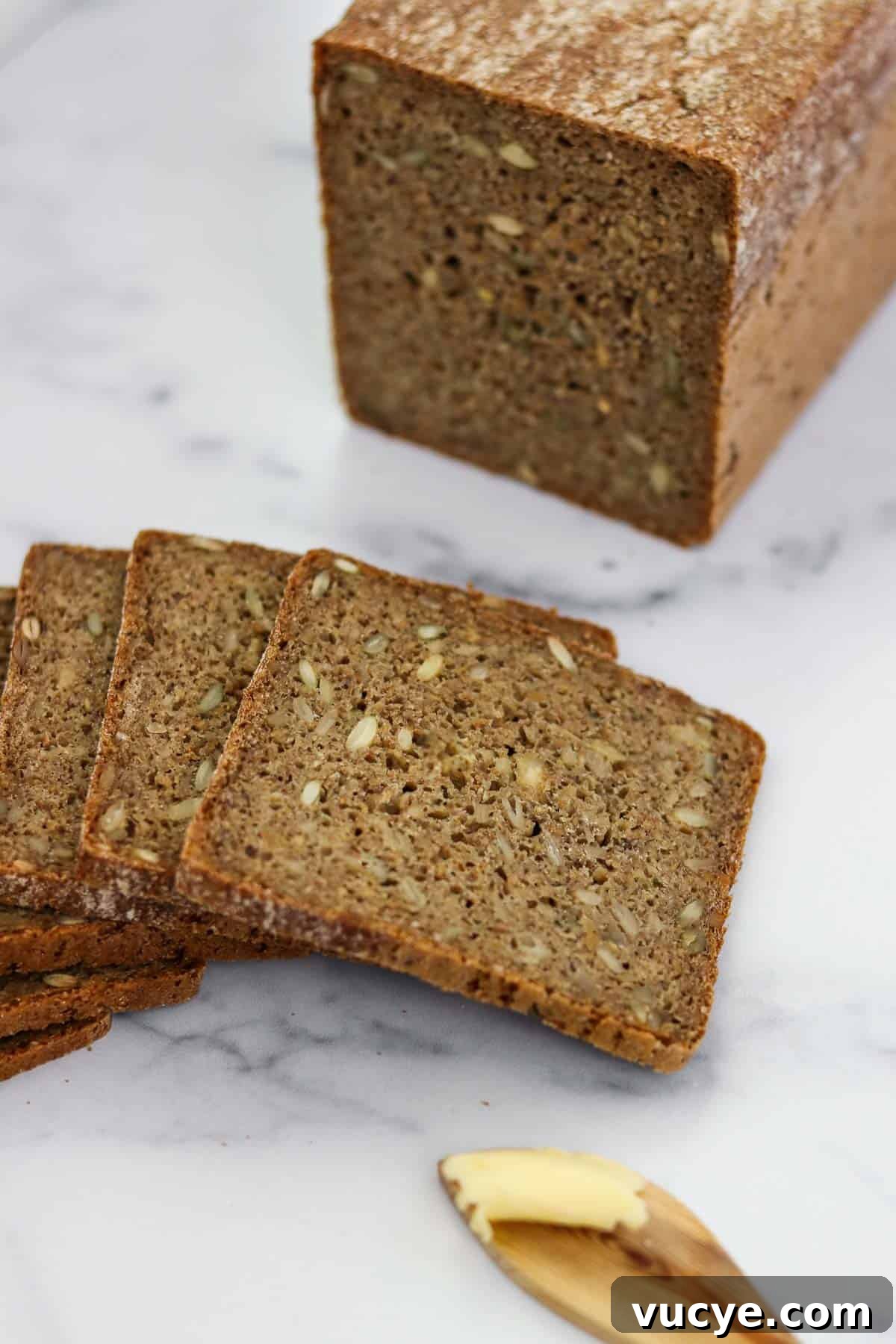 Sliced rye bread on a marble surface.