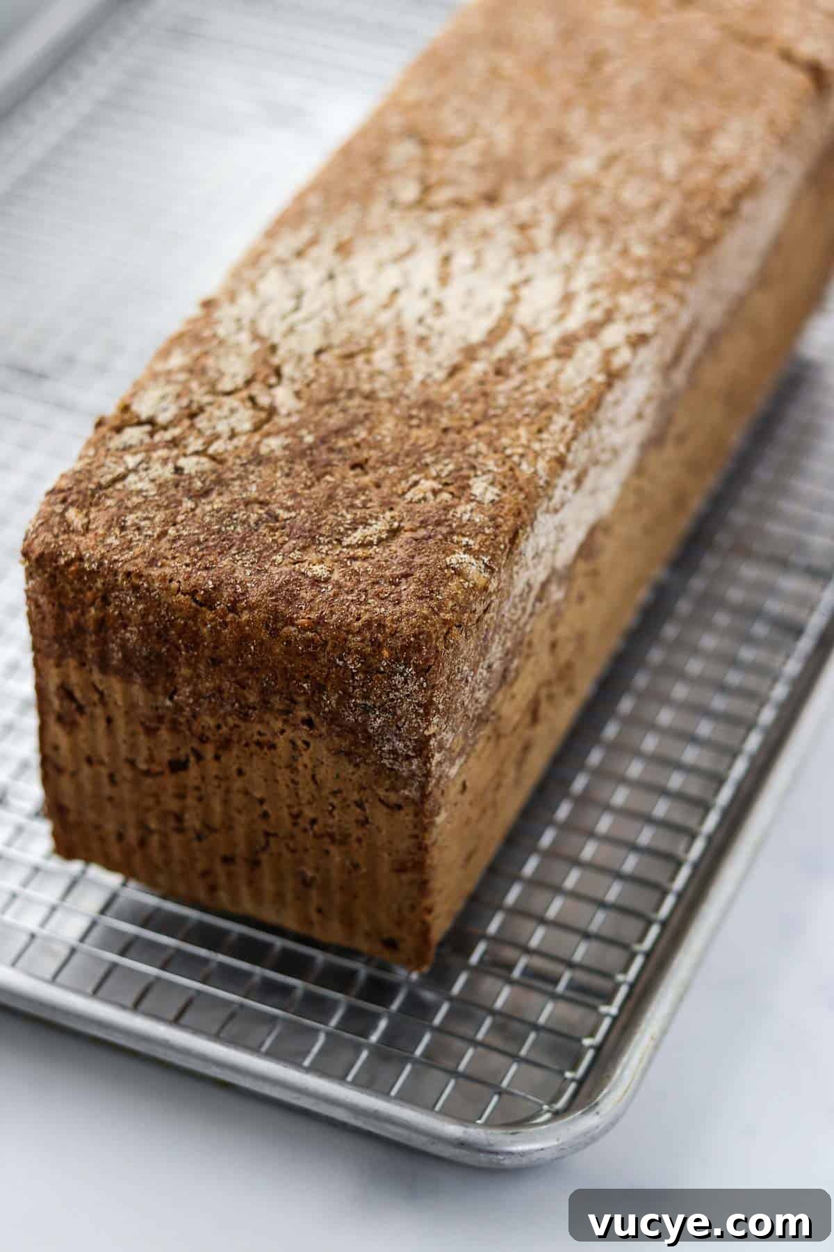 Danish rye bread on a metal cooling rack.