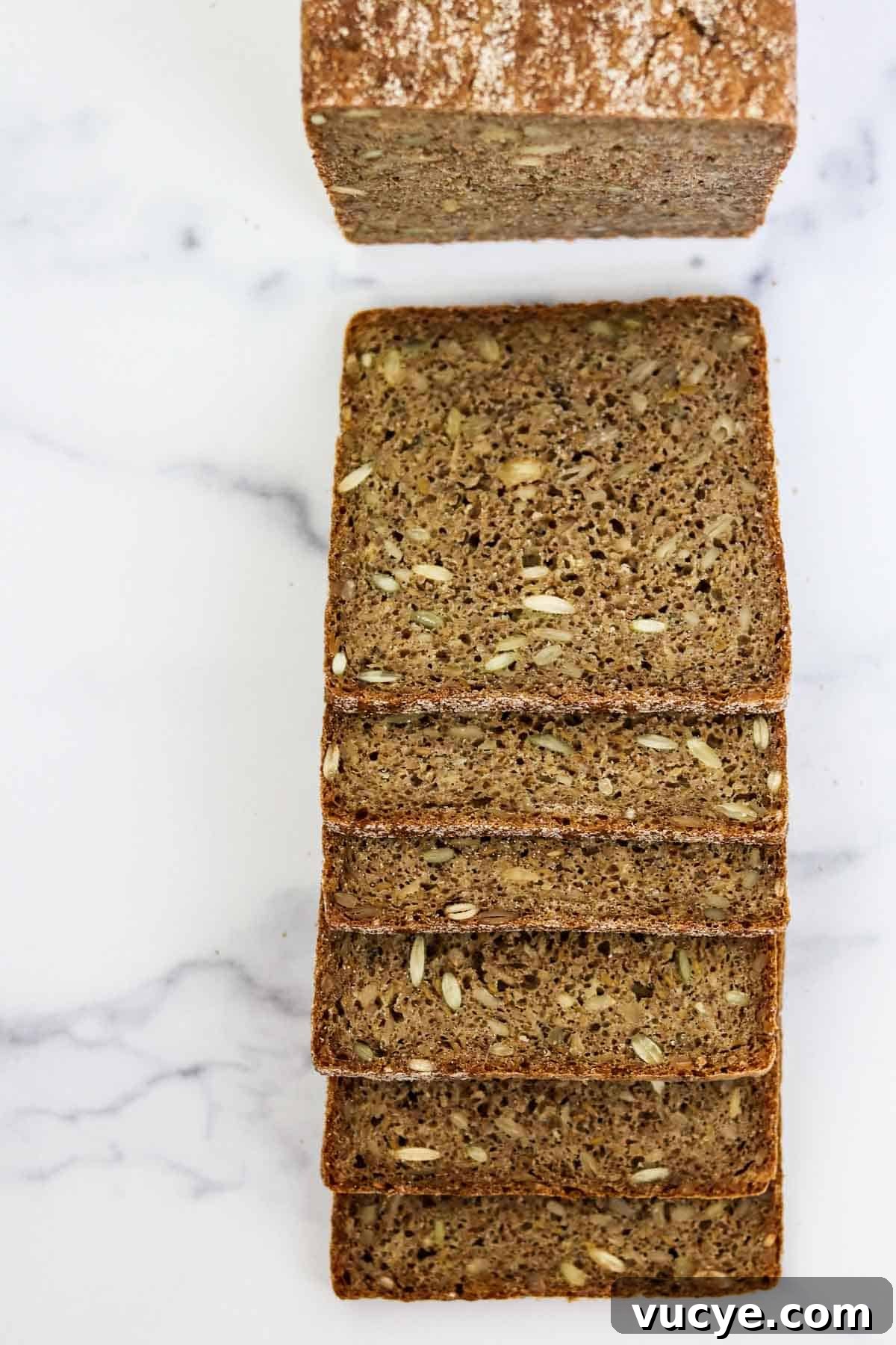 Sliced rye bread on a marble surface.