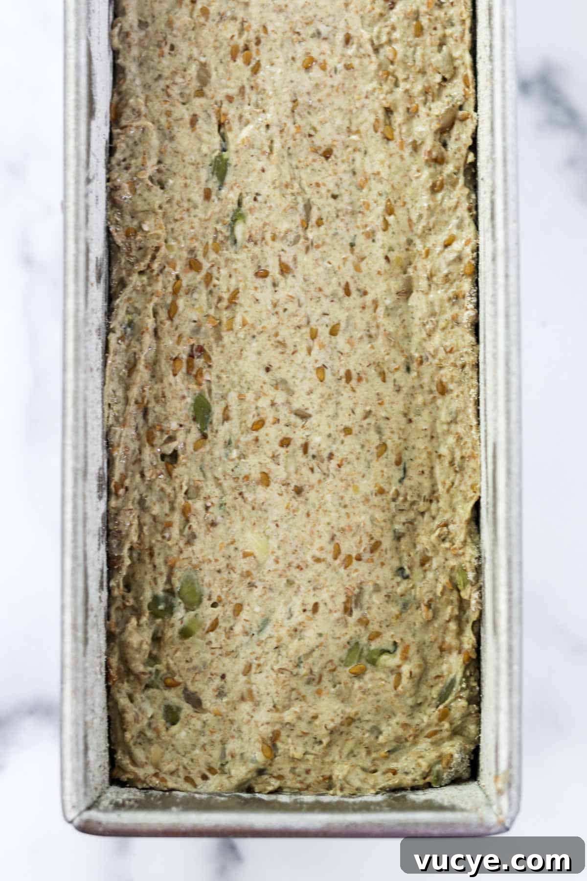 Danish rye bread dough in a loaf pan.