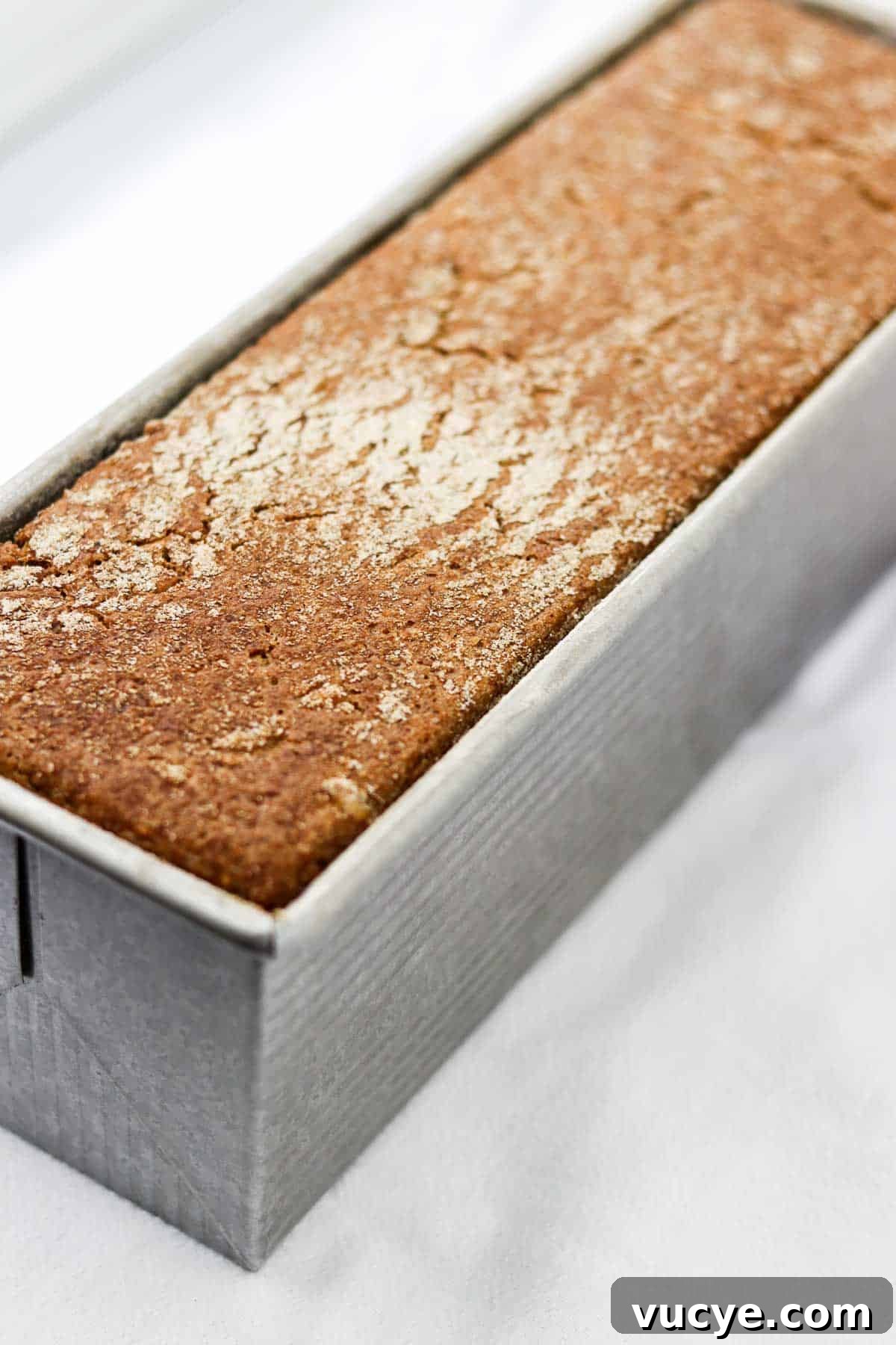 Danish rye bread in a loaf pan.
