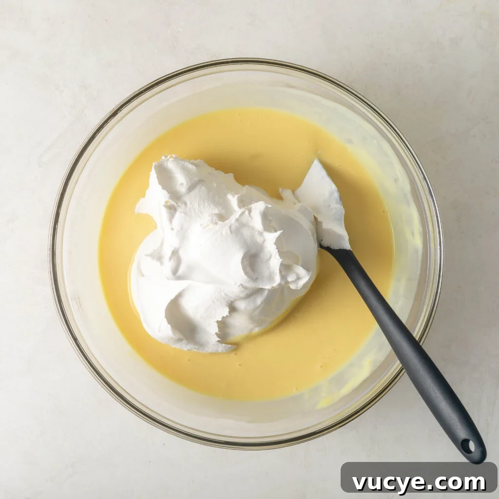 cool whip being folded into pudding mix