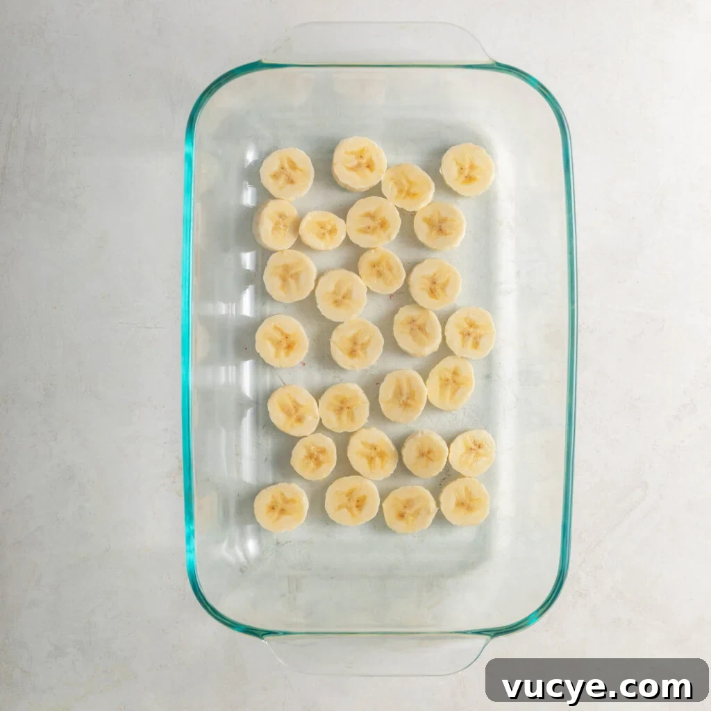 glass casserole dish lined with sliced bananas