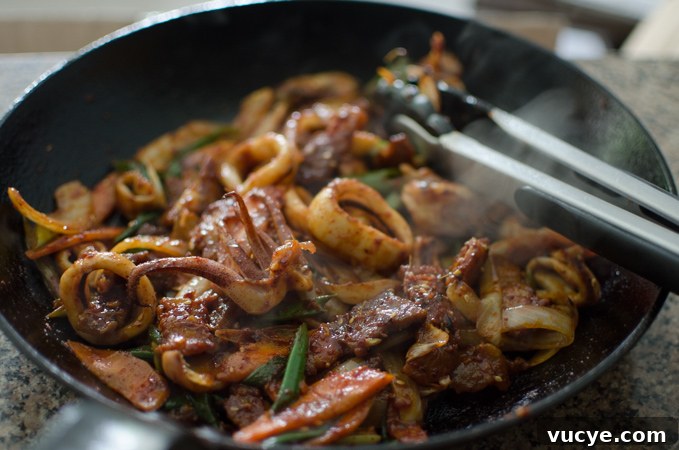 Spicy Pork and Squid Stir-Fry (Osam Bulgogi) Recipe 12 Stir-frying pork and squid with the sauce.