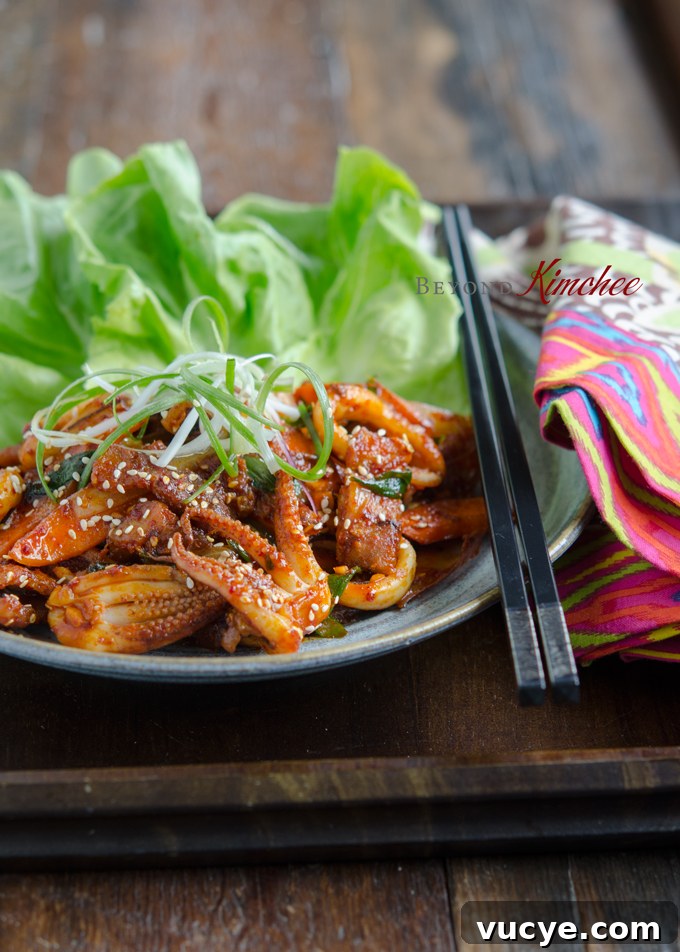 Spicy Pork and Squid Stir-Fry (Osam Bulgogi) Recipe 13 Osam bulgogi served on a serving dish with chopsticks.