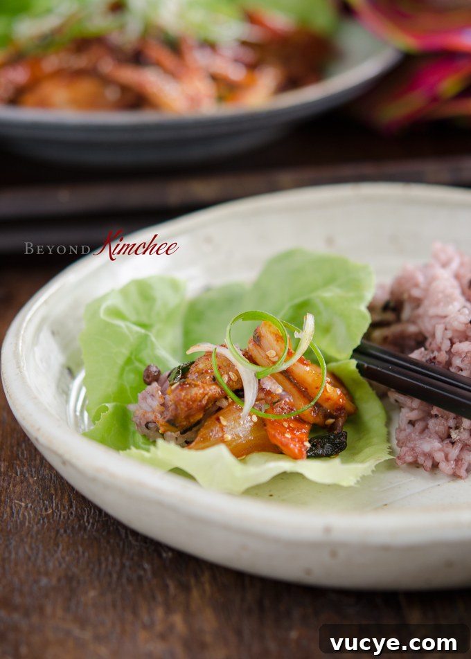 Spicy Pork and Squid Stir-Fry (Osam Bulgogi) Recipe 14 Spicy pork belly and squid stir-fry in a lettuce wrap.