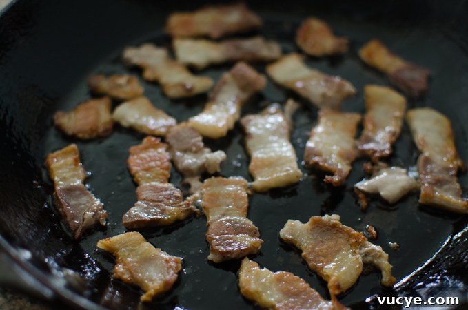 Spicy Pork and Squid Stir-Fry (Osam Bulgogi) Recipe 5 Pork belly fried in a skillet.