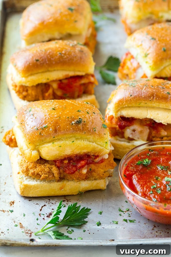 Chicken Parmesan Sliders Chicken parmesan sliders made with crispy chicken, marinara sauce and cheese on buns.