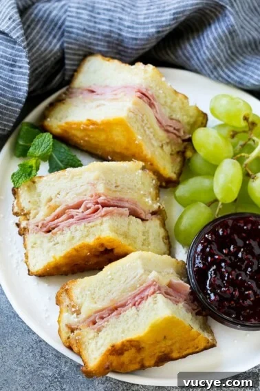 Chicken Parmesan Sliders Recipe: Crispy Mini Sandwiches for Parties 2 A plate of Monte Cristo sandwich with fresh fruit and raspberry jam for dipping.