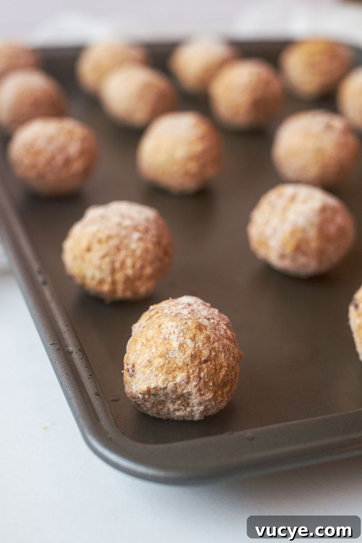 close up view of how to cook frozen meatballs in oven on a baking sheet