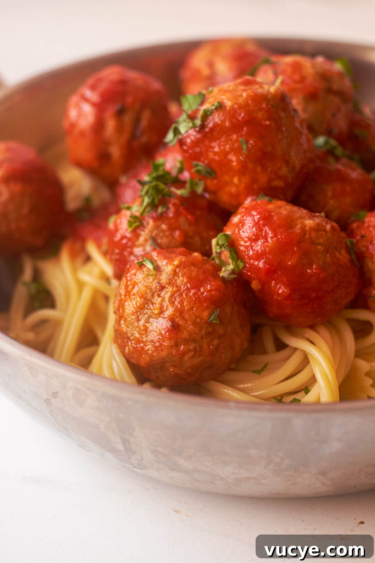 close up of cooked frozen meatballs with pasta and marinara sauce