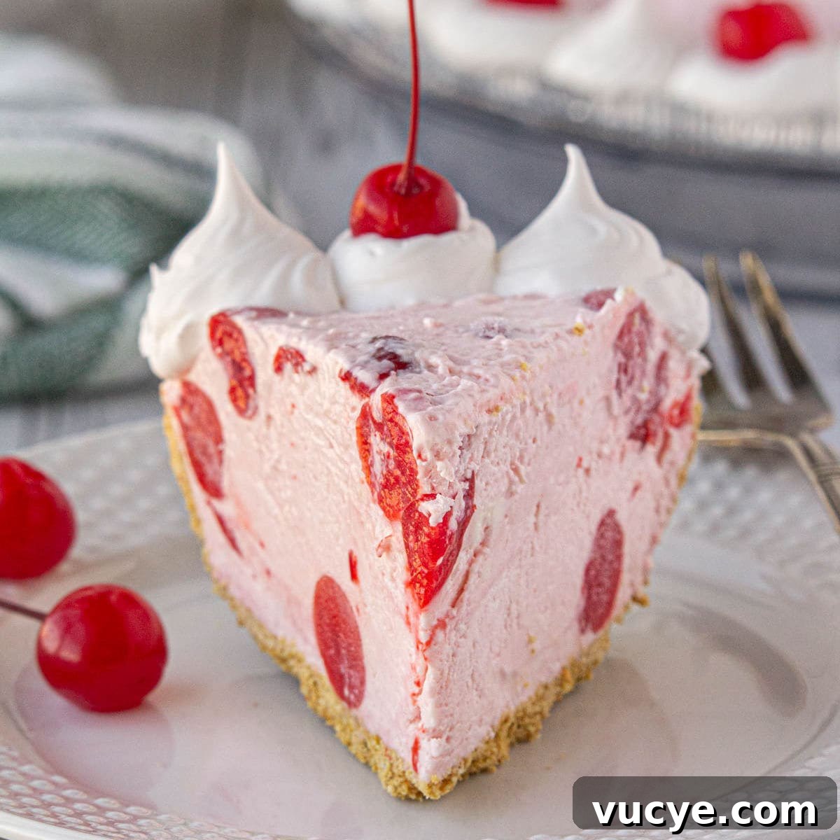 A slice of cherry icebox pie with whipped cream on top.