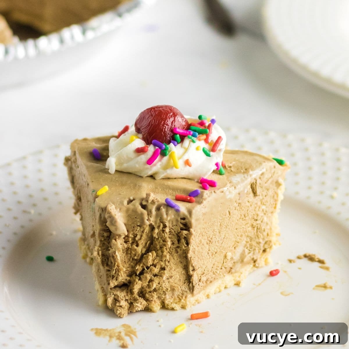 A slice of root beer float icebox pie on a white plate.