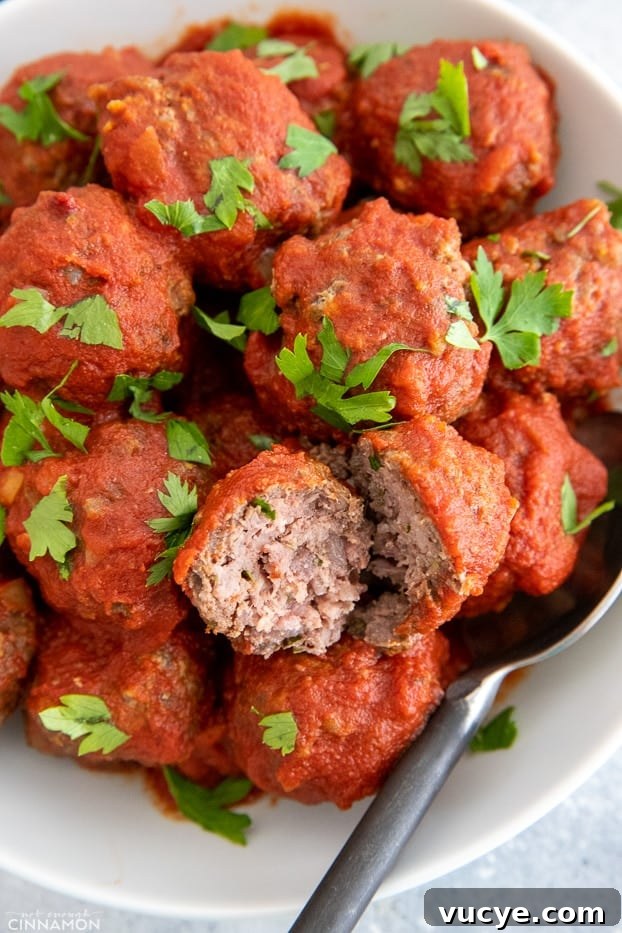 healthy bbq slow cooker meatballs served in a white bowl sprinkled with cilantro 