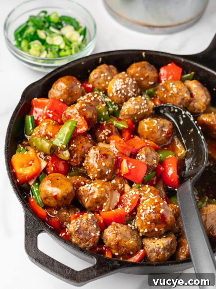 sweet chili meatballs with onion, bell pepper and snap peas in a skillet