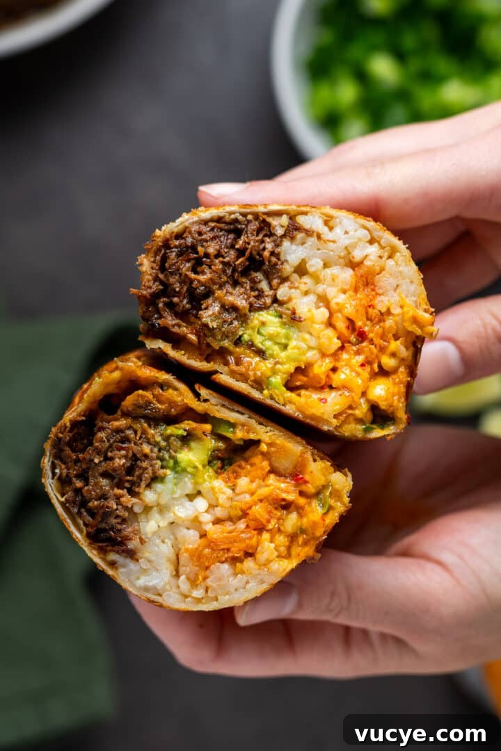 hands holding a burrito made from leftover Korean shredded beef, kimchi, rice, avocado and sriracha mayo
