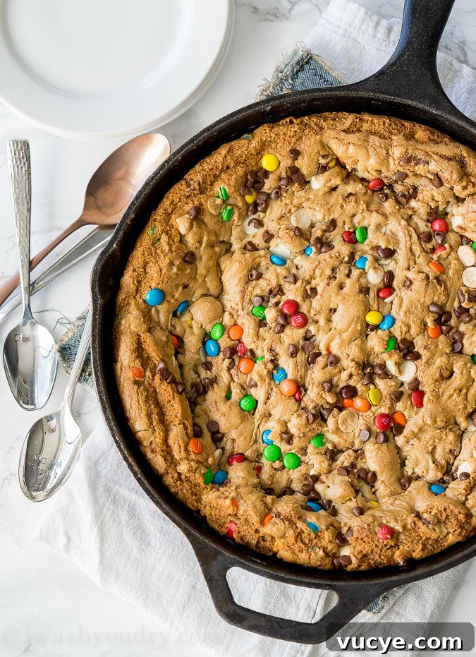 Skillet cookie served warm with ice cream and syrup
