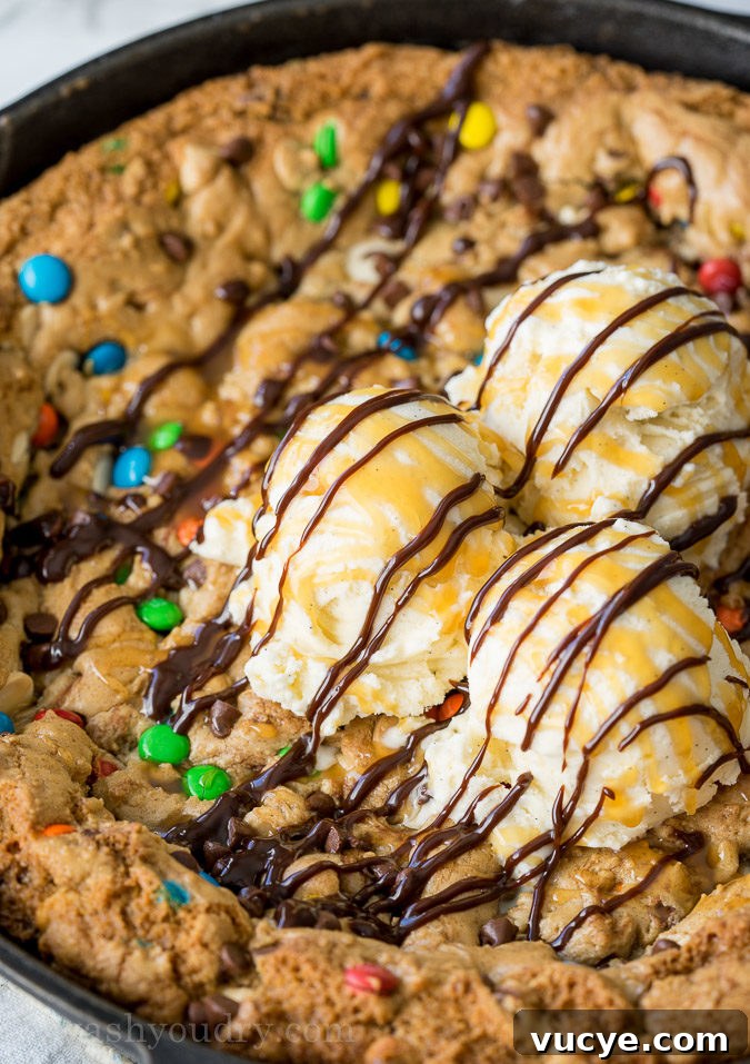 Slice of cookie cake topped with ice cream
