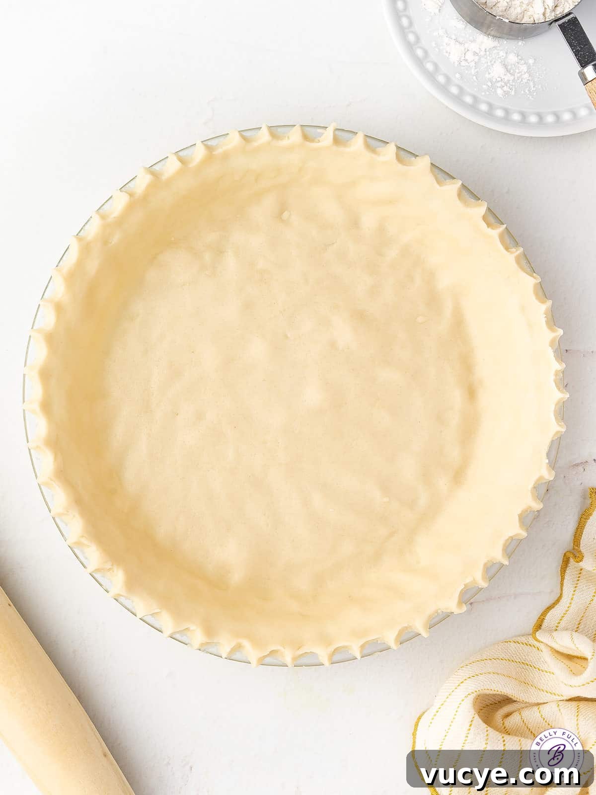 overhead unbaked pie crust with crimped edges