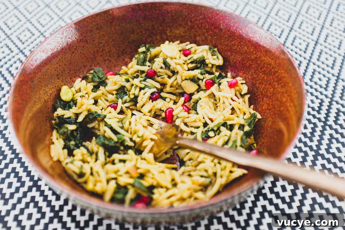 A small bowl holds some Moroccan rice with Silverbeet, garnished with pomegranate seeds