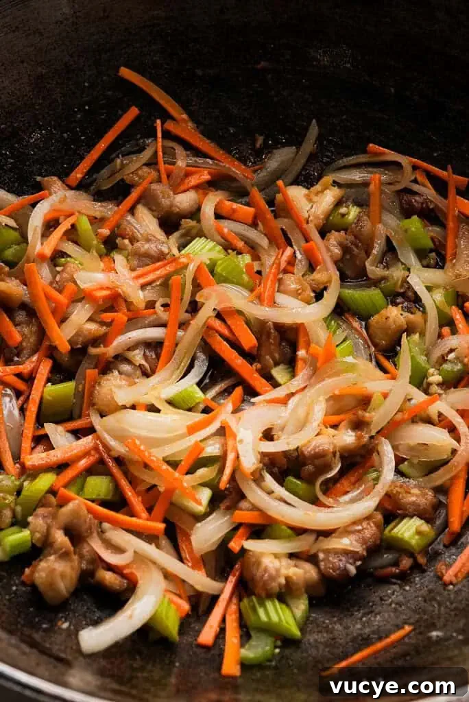 Sautéed mixture in pan with sauce.