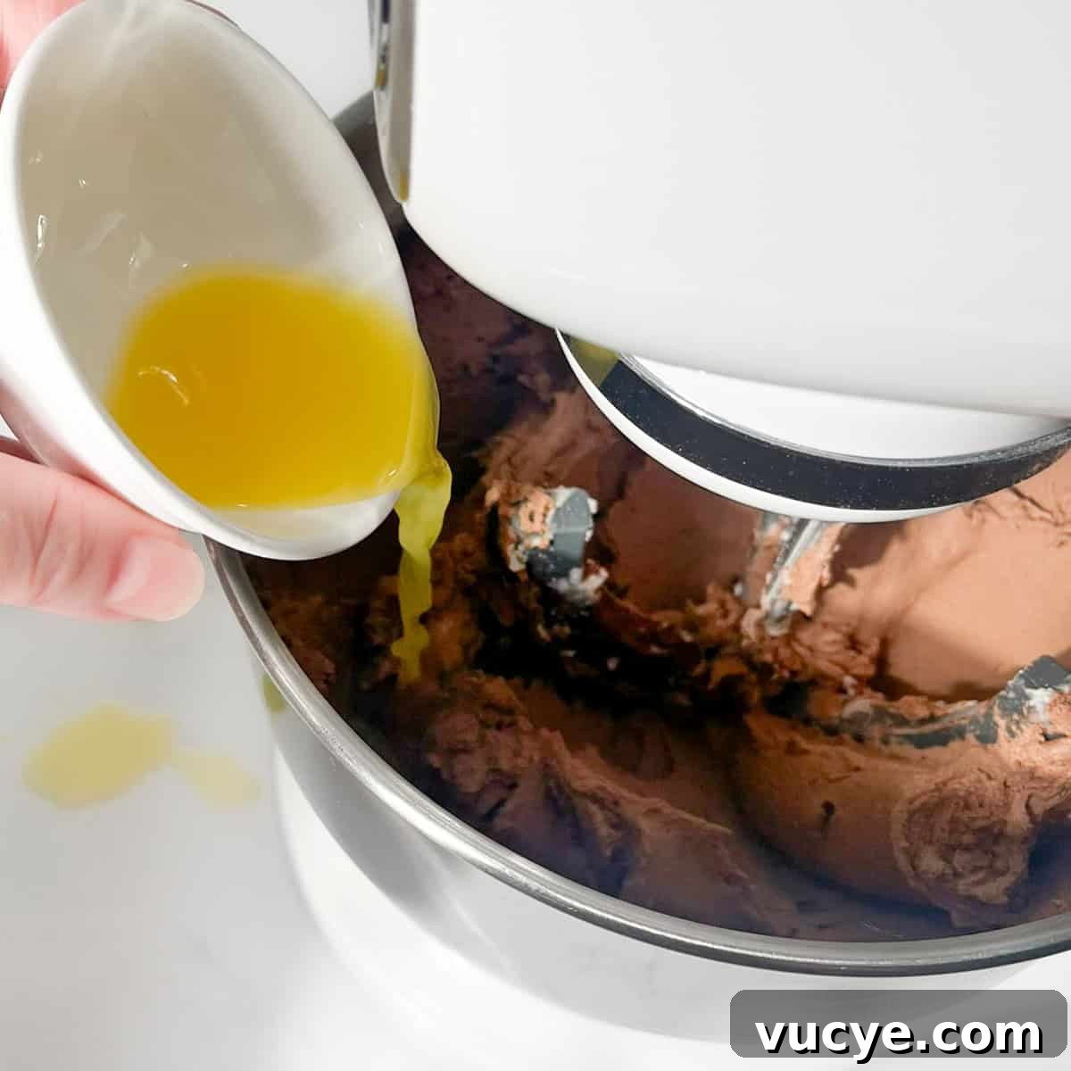 Thinning the buttercream with some orange juice.