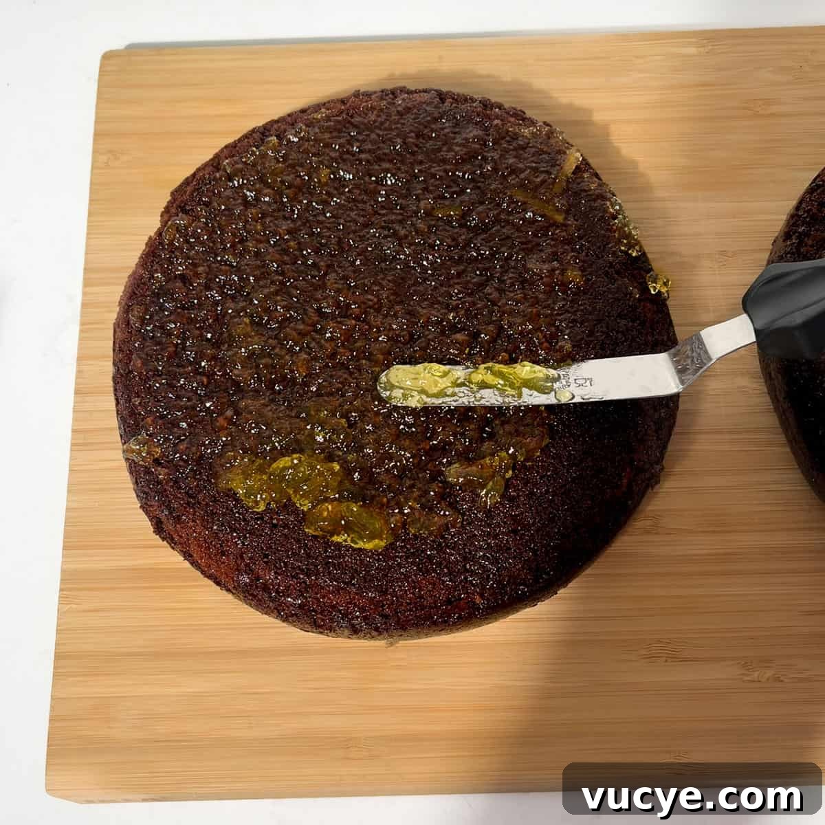 Spreading marmalade on the chocolate orange cake.