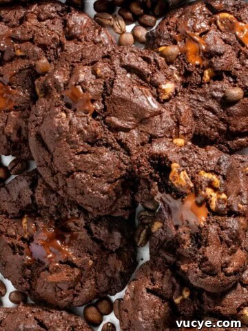 Chocolate chip coffee cookies on a white tray surrounded by coffee beans.