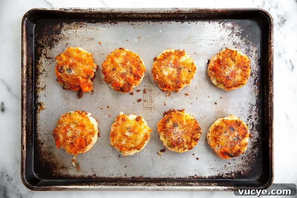 Overhead shot of potato salmon cakes on a baking sheet.