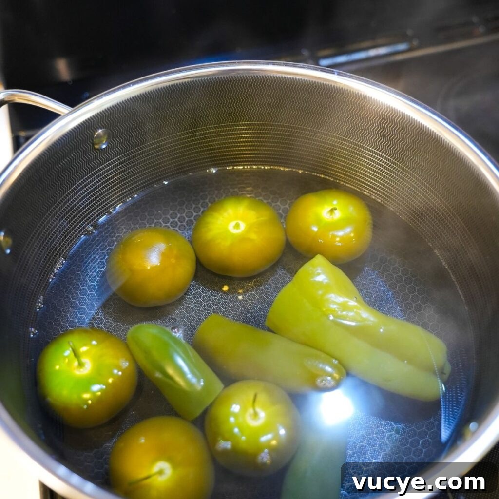 Tomatillos and peppers boiling for salsa.