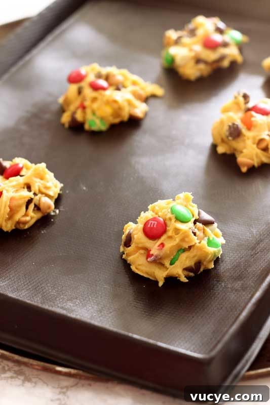 Flexipan containing 5 raw cookie dough balls for Boyfriend Cookies, topped with red and green M&Ms.