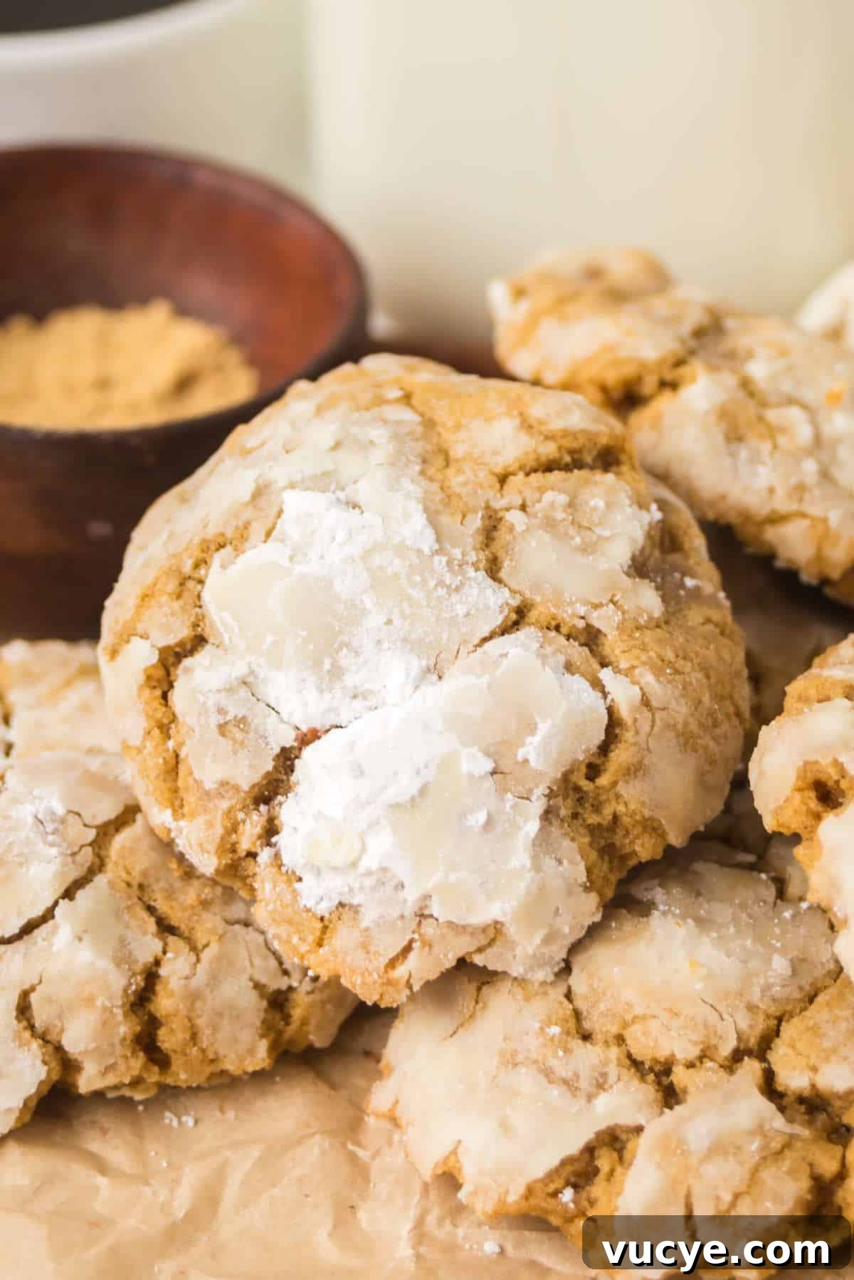 Soft gingerbread crinkle cookies stacked together with powdered sugar crackled tops and thick, tender texture