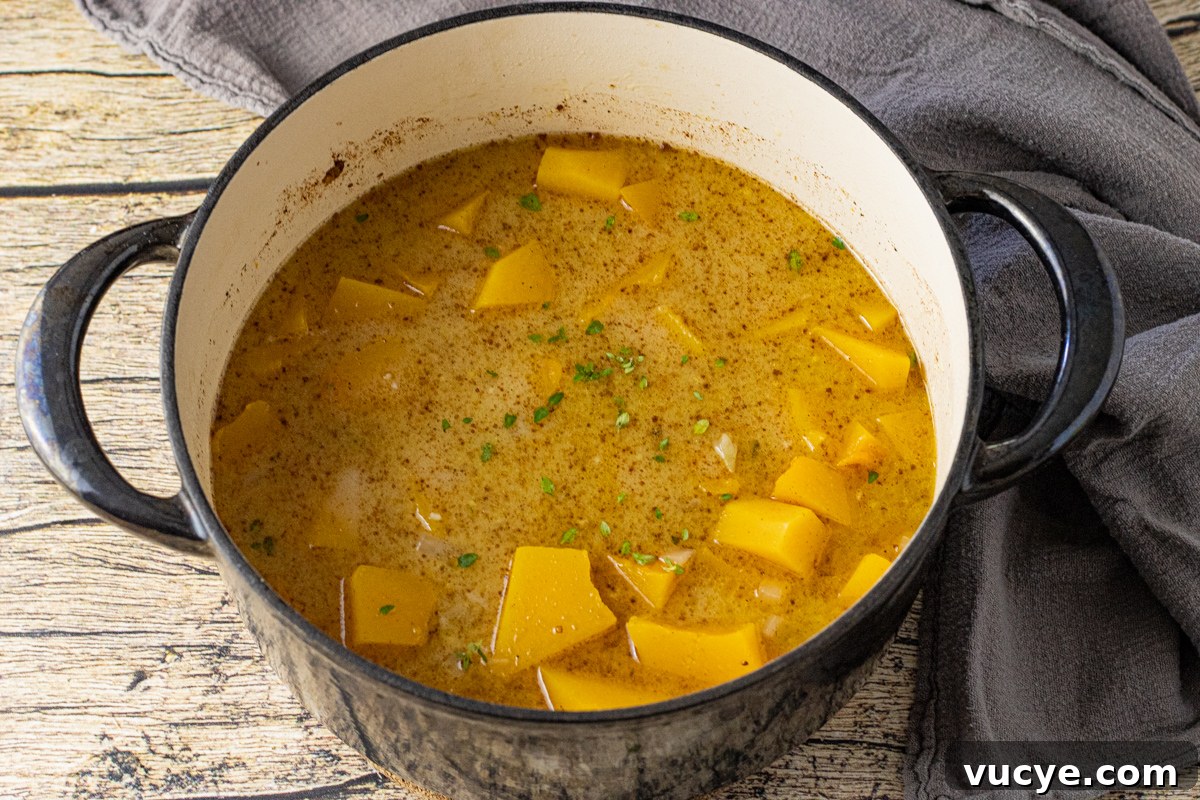 butternut squash in a pot covered with broth