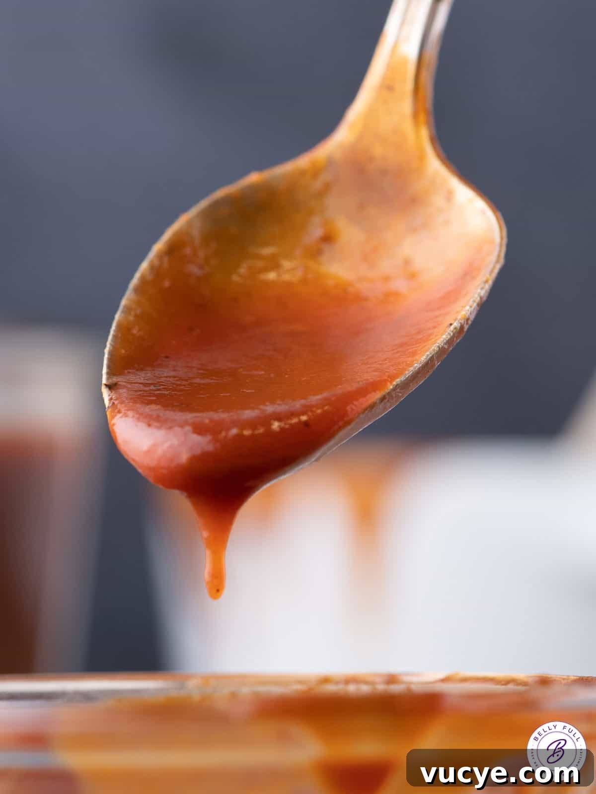 Homemade BBQ sauce dripping off a spoon