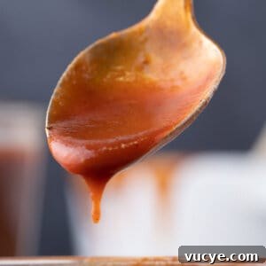 Homemade BBQ sauce dripping off a spoon