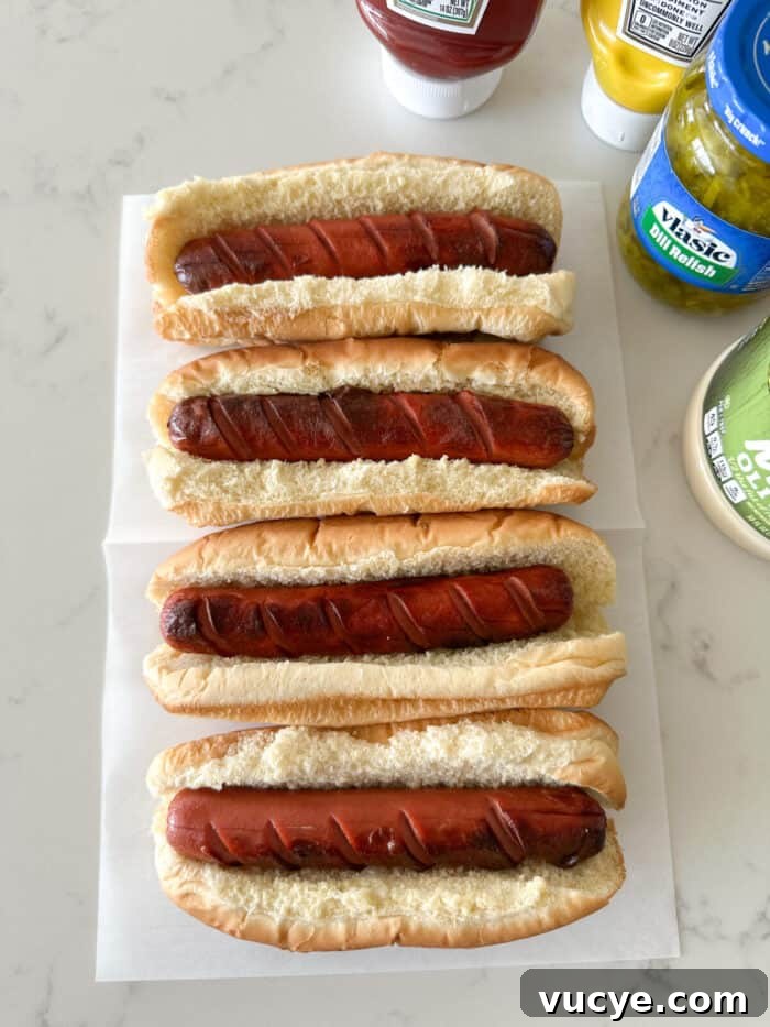 hot dogs in buns on counter top ready for toppings